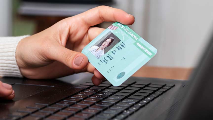 Hand holding a green card with focus on the card